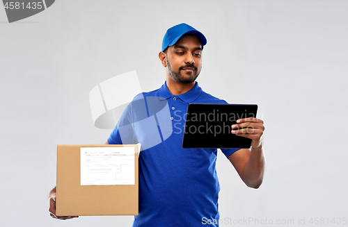 Image of indian delivery man with tablet pc and parcel box