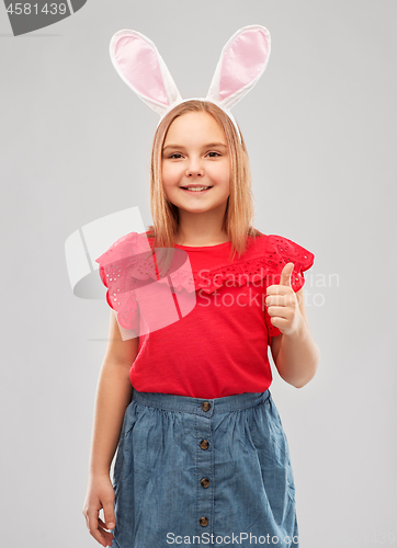 Image of girl wearing easter bunny ears showing thumbs up