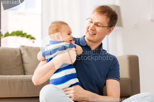 Image of happy father with baby son at home