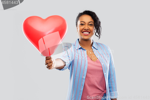 Image of african american woman with heart-shaped balloon