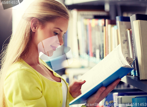 Image of high school student girl reading book at library