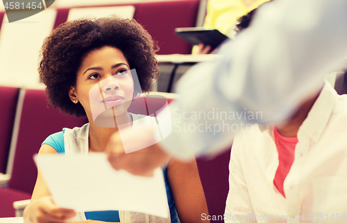 Image of teacher giving test to student girl on lecture