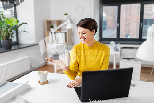 Image of businesswoman using smart speaker at office