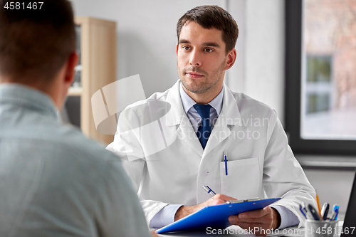 Image of doctor with clipboard and male patient at hospital