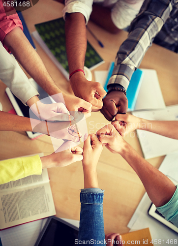 Image of group of international students making fist bump