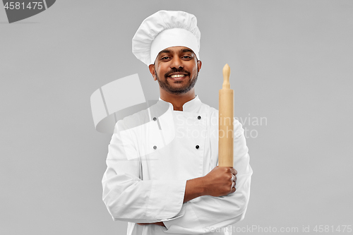 Image of happy male indian chef or baker with rolling-pin