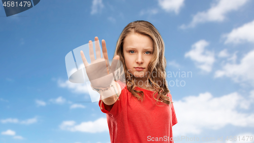 Image of serious teenage girl showing stop gesture