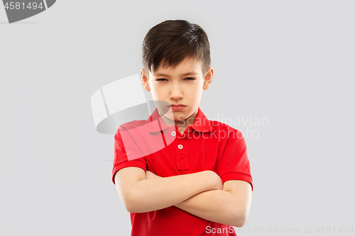 Image of displeased boy in t-shirt pouting and squinting