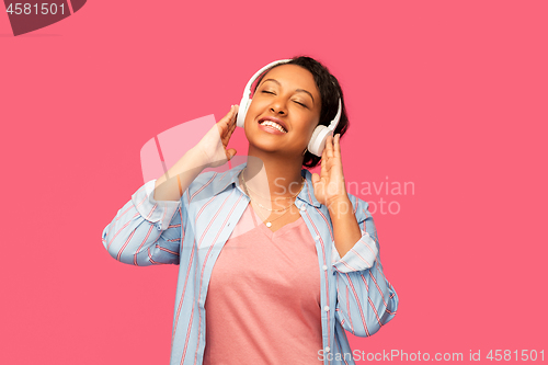 Image of african woman in headphones listening to music