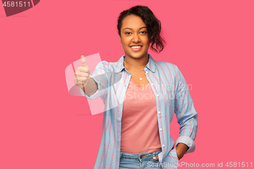 Image of happy african american woman showing thumbs up