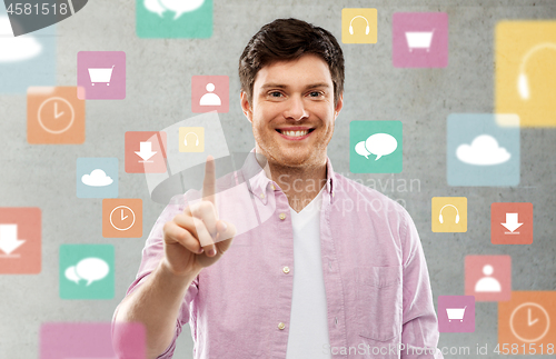 Image of man showing one finger over app icons on grey