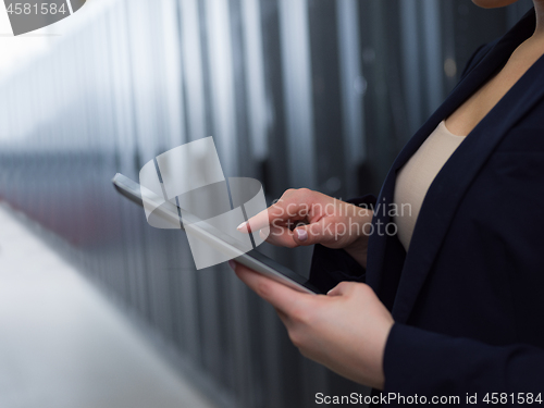 Image of Female engineer working on a tablet computer in server room