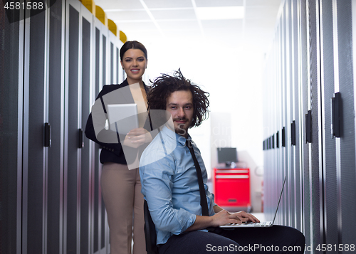 Image of Team of young technicians working together on servers