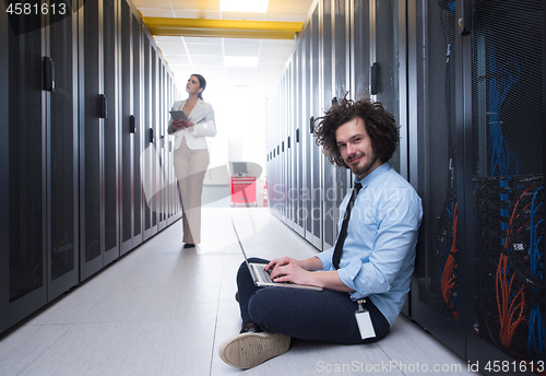 Image of Team of young technicians working together on servers