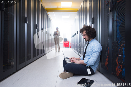 Image of Team of young technicians working together on servers