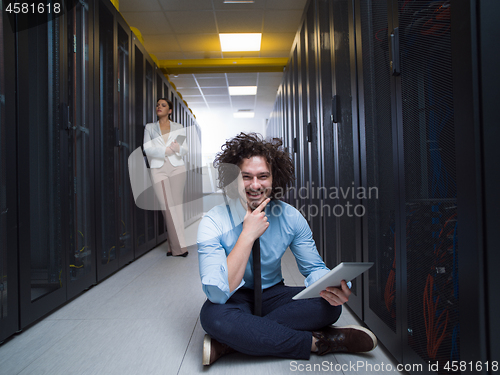 Image of young technicians working together on servers