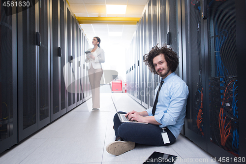 Image of Team of young technicians working together on servers