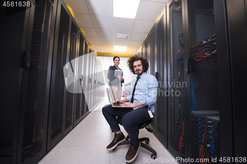Image of Team of young technicians working together on servers