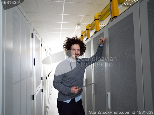 Image of IT engineer working on a tablet computer in server room