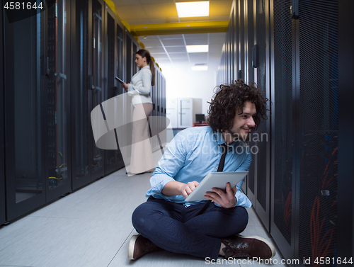 Image of young technicians working together on servers