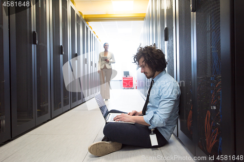 Image of Team of young technicians working together on servers