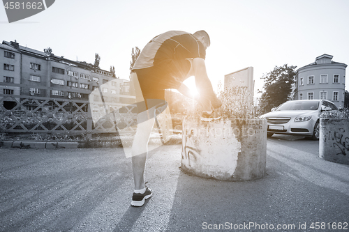 Image of man tying running shoes laces