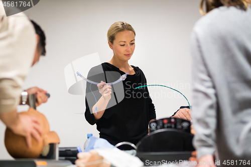 Image of Medical doctor specialist expert displaying method of patient intubation technique on hands on medical education training and workshop