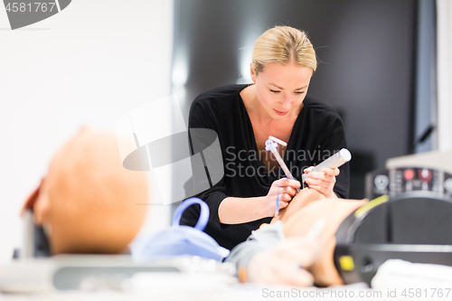 Image of Medical doctor specialist expert displaying method of patient intubation technique on hands on medical education training and workshop