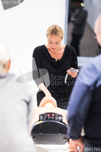 Image of Medical doctor specialist expert displaying method of patient intubation technique on hands on medical education training and workshop