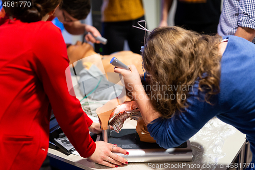 Image of Medical doctor specialist expert displaying method of patient intubation on hands on medical education training and workshop. Participants learning new medical procedures and techniques.