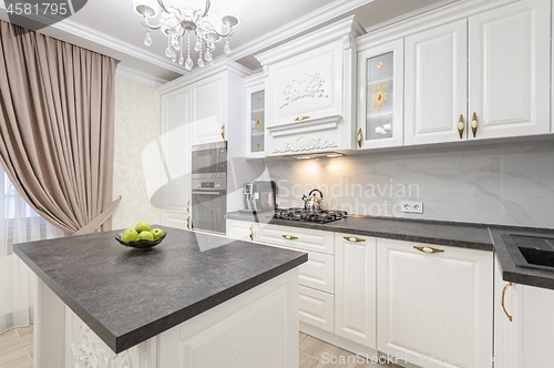 Image of White luxury modern kitchen with island