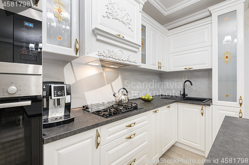 Image of White luxury modern kitchen with island