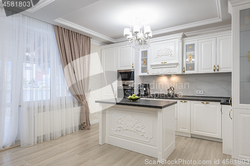 Image of White luxury modern kitchen with island