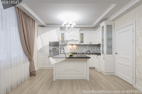 Image of White luxury modern kitchen with island