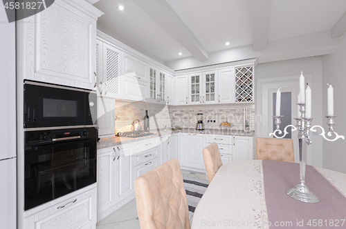 Image of modern white wooden kitchen interior