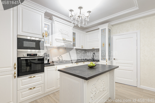 Image of White luxury modern kitchen with island