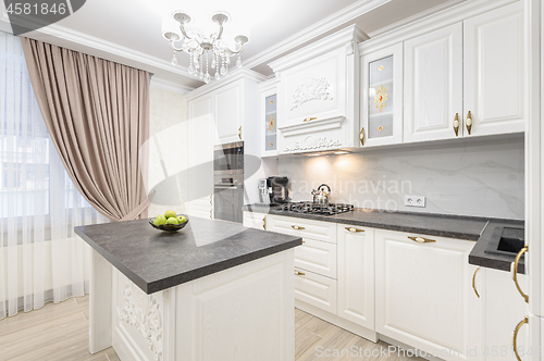 Image of White luxury modern kitchen with island