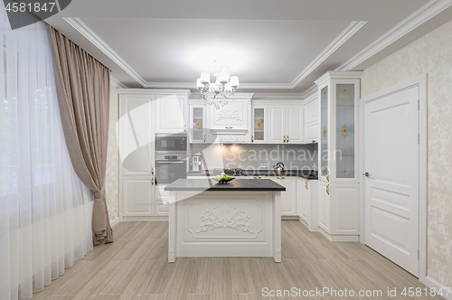 Image of White luxury modern kitchen with island