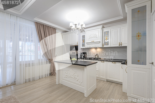 Image of White luxury modern kitchen with island