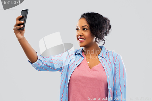 Image of african american woman taking selfie by smartphone