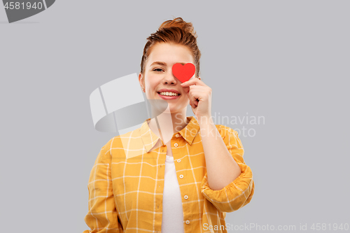 Image of smiling red haired teenage girl with heart