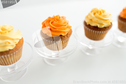 Image of cupcakes with frosting on confectionery stands