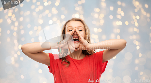 Image of happy teenage girl in red t-shirt shouting