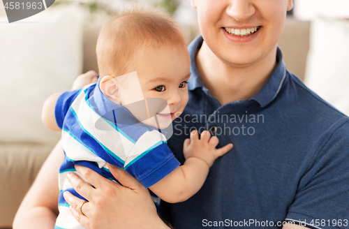 Image of happy baby son with father at home