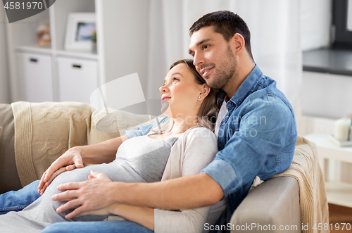 Image of man hugging pregnant woman at home