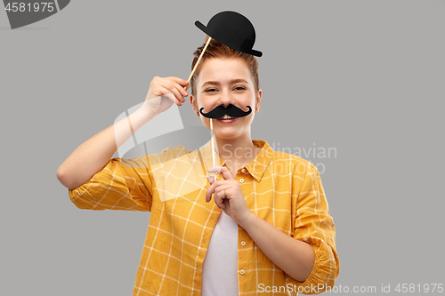 Image of red haired teenage girl with black moustaches