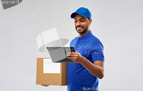 Image of indian delivery man with tablet pc and parcel box