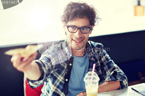 Image of happy man with cash money paying at cafe