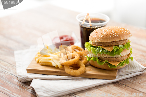 Image of close up of fast food and cola drink on table