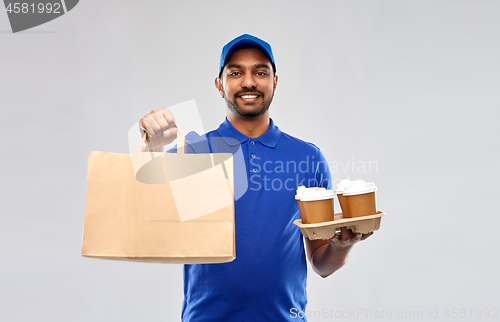 Image of happy indian delivery man with food and drinks